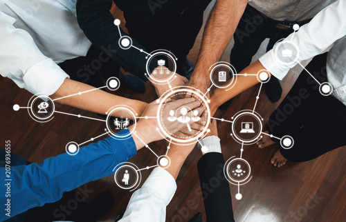 Fotografía Group of diverse office worker join hand together in office room symbolize business synergy and strong productive teamwork in workplace