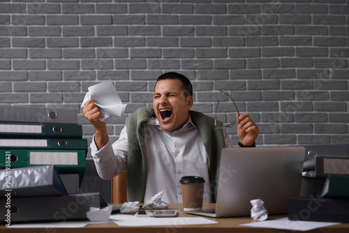 Angry businessman working a...