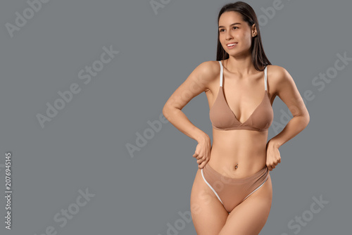 Slim young woman in beige c...