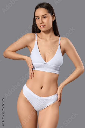 Slim young woman in white c...