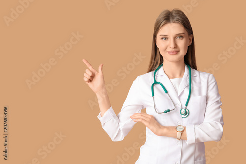 Beautiful doctor pointing a...