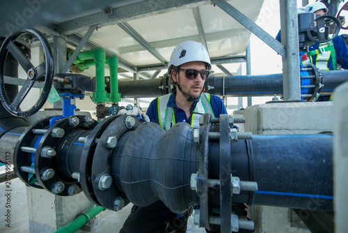 Photography Engineer maintenance hvac cooling tower pipe valve inspection underway as focuse