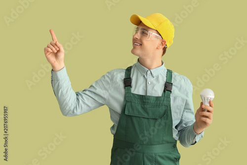 Male electrician with light...