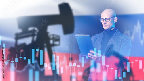 Oil industry, analyst uses tablet with oil pump silhouette and market chart against Russian flag for energy trading concept