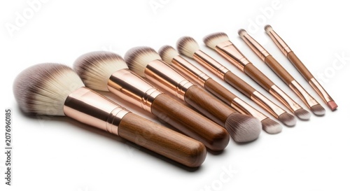 Professional cosmetic makeup brushes set with soft bristles and rose gold metal handles arranged on white background cosmetic professional application skincare bristles collection