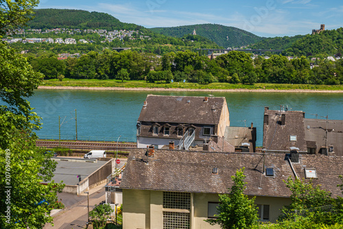 Foto River Valley Landscape with European Town Houses, Railway Track and Green Hills