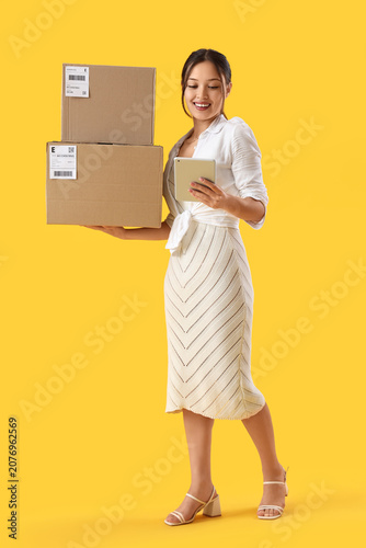 Young Asian seller with tab...