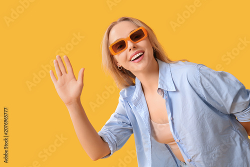 Young beautiful woman wavin...