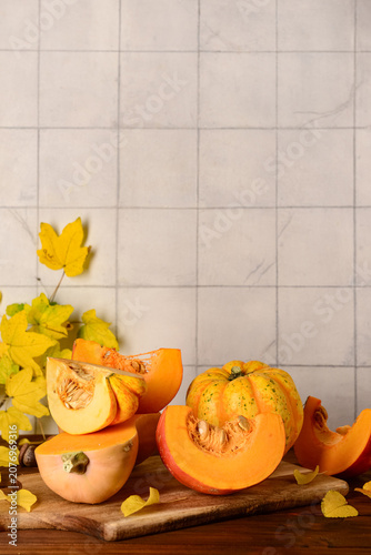Board with cut fresh pumpki...