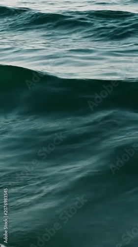The dark blue ocean waves roll across the deep sea surface