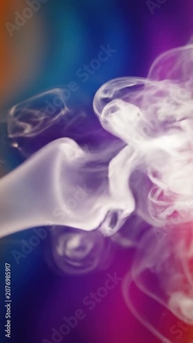 White smoke swirls against a vibrant blue and purple background