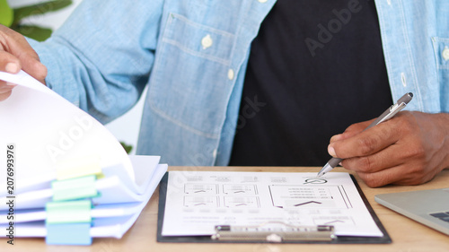 Canvas Print Business professional reviewing documents and organizing paperwork with a clipbo