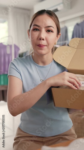 POV Gen Z vlogger SME owner go green zero waste thrift store sale live stream talk on social media online second hand sell. Asia people young woman record home AI video camera app eco shop side hustle