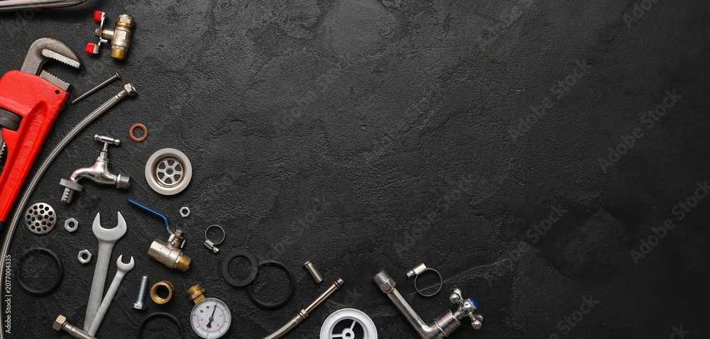Fototapeta premium Plumbing tools and parts on black background