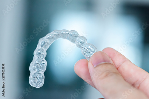  clear aligners device in the mouth on a white background. (invisalign)
