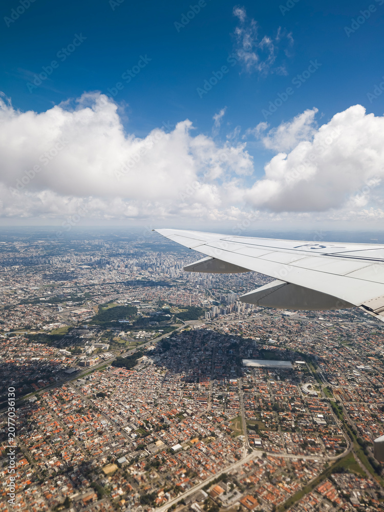 Fototapeta premium View from an airplane window looking out over beautiful clouds and blue sky during flight.