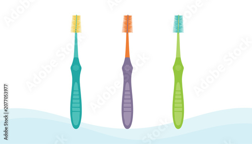Set of three interdental toothbrushes with yellow, orange, and blue bristles on green, purple, and blue handles.