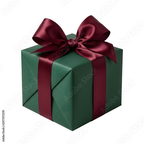 A festive dark green gift box is tied with a luxurious deep red satin ribbon and bow isolated on a white background