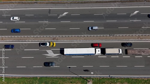 Aerial view of a congested highway in Italy. Traffic is at a standstill as trucks and cars fill the roadway.