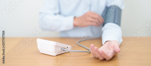 Photos Man checking Blood pressure by Blood pressure monitor with Cuff