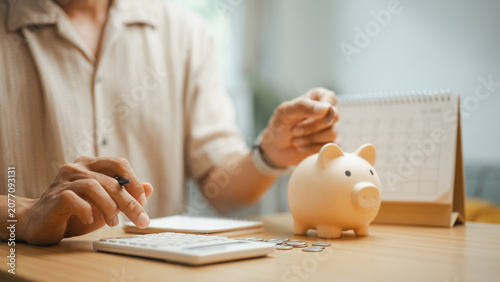 Bild auf Leinwand Person managing a budget with a calculator, piggy bank, and monthly planner, representing personal finance, savings goals, expense tracking, and smart financial planning for future stability