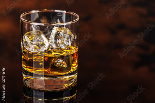 Glass of whiskey with ice