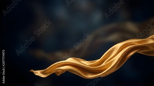 Golden silk fabric flowing gracefully on a dark abstract background