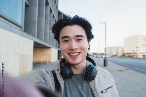 Young asian man smiling taking selfie lifestyle