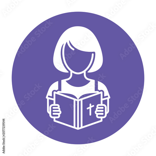 Woman reading holy book with cross symbol on cover indoors