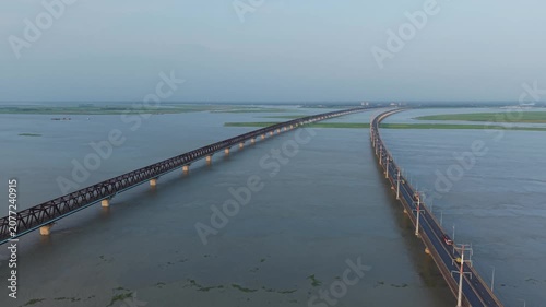 Bridge Over Wide River with Long Truss Spans, Roadway Perspective and Calm Water in Landscape Travel Setting