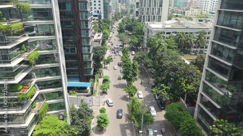 City Street View From Above with Pedestrians, Trees, and Tall Buildings in a Bright Urban Daytime Scene