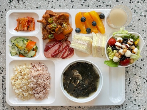 A vibrant spread of Korean food on the table, featuring various banchan (side dishes) like kimchi, pickled vegetables, and seasoned greens. Perfect for food photography, showcasing traditional Korean.