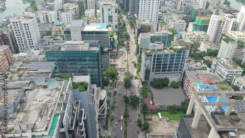 City Street View Between Tall Buildings with Traffic and Greenery, Captured From Above in an Urban Aerial Travel Scene