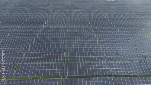 Solar Panels Grid Viewed From Above with Geometric Alignment and Sunlight Reflecting Across the Photovoltaic Surface