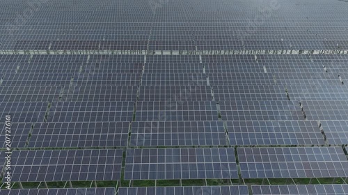 Solar Panel Farm Rooftop View with Grid Pattern Perspective and Technical Lines Across Blue Photovoltaic Cells