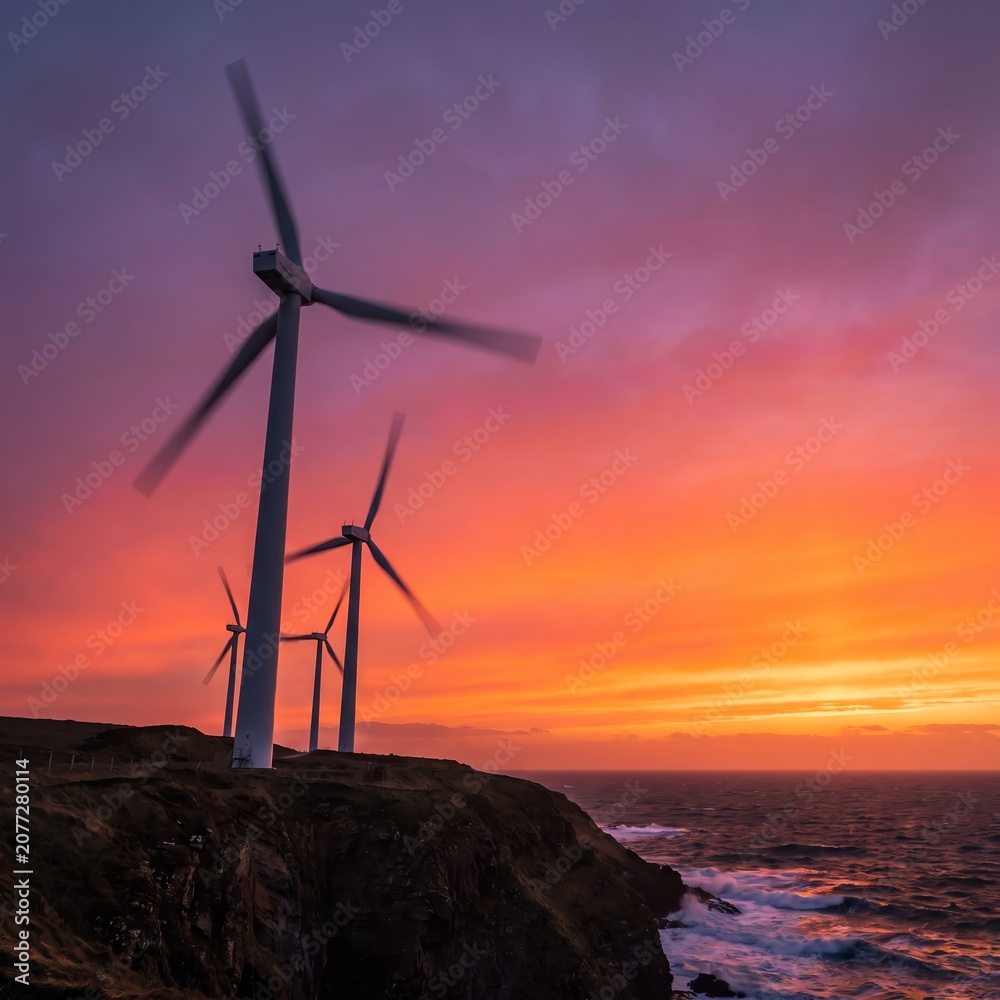 Obraz premium Wind Turbines on Coastal Cliff at Sunset for Renewable Energy
