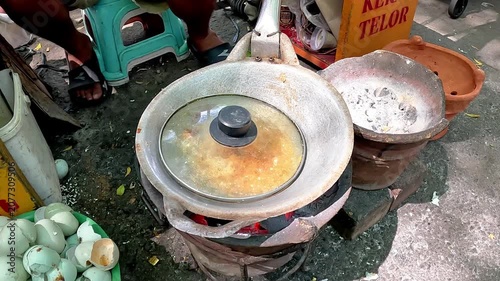 Kerak telor is a dish from the Betawi (Jakarta, Indonesia), consisting of an omelet mixed with white glutinous rice, dried shrimp, and spices.