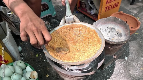 Kerak telor is a dish from the Betawi (Jakarta, Indonesia), consisting of an omelet mixed with white glutinous rice, dried shrimp, and spices.