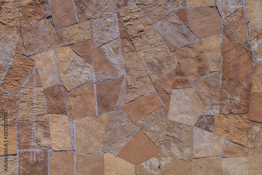 Фотография Weathered stones form a rustic, textured wall