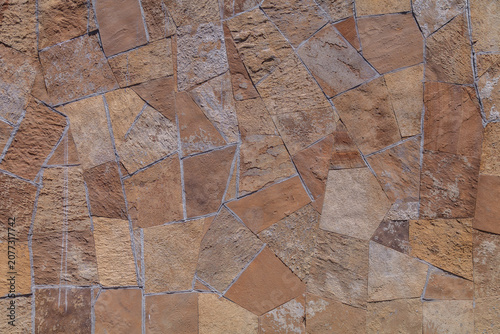 фотографія Weathered stones form a rustic, textured wall