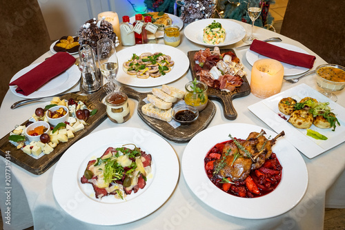 Holiday Dinner Table with Assorted Dishes and Drinks