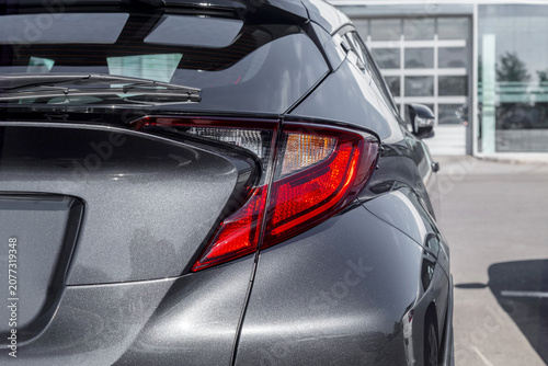 Modern car gleams under bright daylight