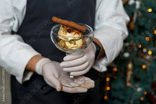 Chef holding a glass of ice cream dessert