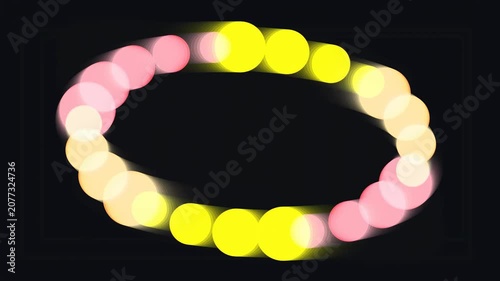 Glowing light ring with pink and yellow dots on dark background