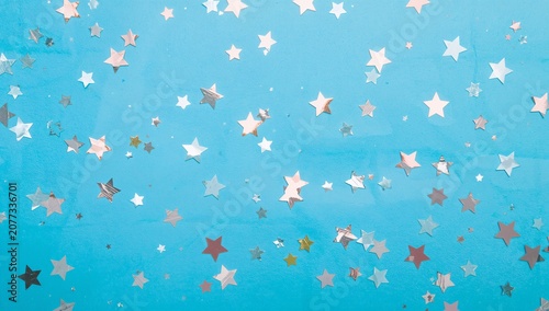 Colorful Star Confetti on Bright Blue Background for Celebrations and Party Decor