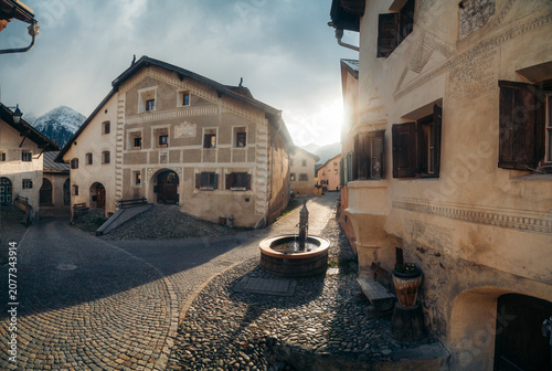 Guarda historic alpine village against snow-capped peaks at sunset, Engadin Valley, Graubünden, Switzerland