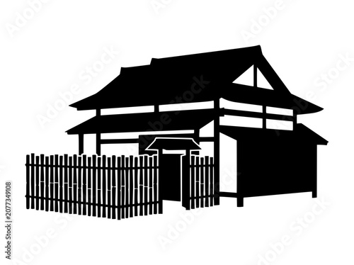 Silhouette of a Traditional Japanese House with Bamboo Fence and Gate