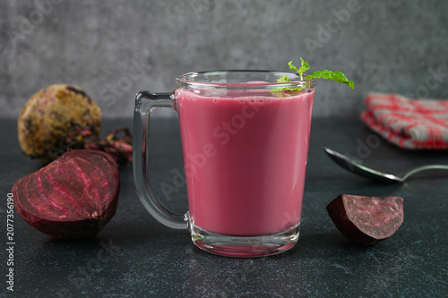 Serving beet smoothie in a glass cup.