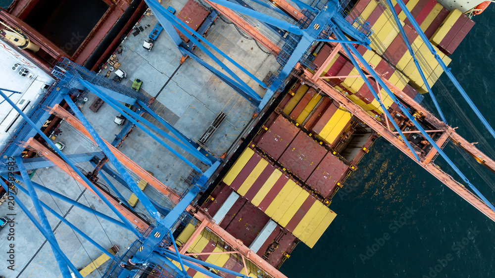 Fototapeta premium Aerial view container ship loaded with cargo box at commercial port terminal, Global business logistic international trade maritime transportation by container ship, Container ship at commercial port.