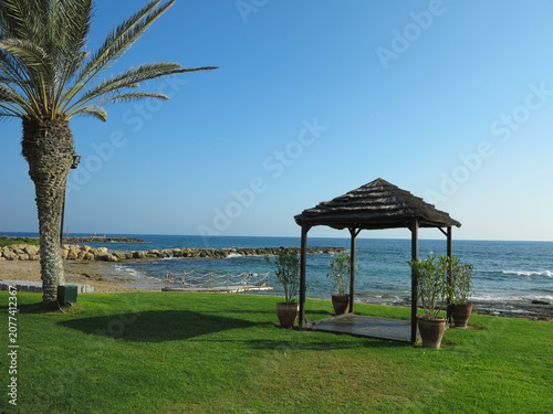 Beautiful landskape, palm trees and sun loungers at luxury resort